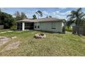 Large backyard with firepit and screened patio at 4495 Amari Rd, North Port, FL 34291