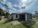 Home exterior showcasing a screened patio and fenced yard at 4495 Amari Rd, North Port, FL 34291