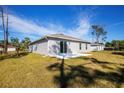 Spacious backyard featuring a concrete patio and plenty of green space at 18059 Regan Ave, Port Charlotte, FL 33948