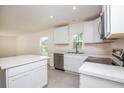 Bright kitchen with white cabinets, stainless steel appliances, and center island at 18059 Regan Ave, Port Charlotte, FL 33948