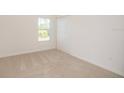 Cozy bedroom with plush carpet and a window offering natural light at 17384 Robinson Ave, Port Charlotte, FL 33948