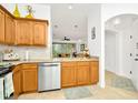 Modern kitchen with wood cabinets, granite counters, and stainless steel appliances at 2111 Tetley Ct, Brandon, FL 33510