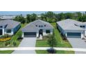 An aerial view shows this home in a neighborhood with manicured lawns and neatly arranged residences at 4990 Fairhope Cir, Lakewood Ranch, FL 34211
