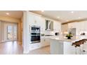 Modern white kitchen with stainless steel appliances and a bright, open design at 4845 Carova Way, Lakewood Ranch, FL 34211