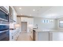 Spacious kitchen with white cabinets, quartz countertops, and stainless steel appliances at 4845 Carova Way, Lakewood Ranch, FL 34211