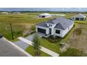 Single-Gathering home with gray tile roof and paver driveway at 4845 Carova Way, Lakewood Ranch, FL 34211