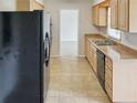 Eat-in kitchen with light wood cabinets and stainless steel appliances at 716 Fox Hills Dr, Sun City Center, FL 33573