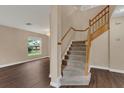 Well-lit staircase with carpeted steps and wooden railing at 1712 Scotch Pine Dr, Brandon, FL 33511