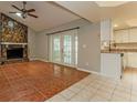 Living room with tile floors, stone fireplace, and french doors at 3720 Orangepointe Rd, Valrico, FL 33596