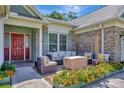 Cozy patio with wicker furniture and colorful flowers at 15617 Indian Queen Dr, Odessa, FL 33556