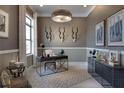 Home office with large desk, stylish decor, and natural light at 8904 Bernini Pl, Sarasota, FL 34240