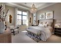 Bright and airy main bedroom with sitting area and golf course views at 8904 Bernini Pl, Sarasota, FL 34240