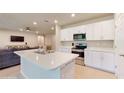 Modern kitchen featuring white cabinets and stainless steel appliances at 108 Castile Ct, Punta Gorda, FL 33983