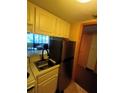 Simple kitchen with stainless steel fridge at 36750 Us Highway 19 N # 13-216, Palm Harbor, FL 34684