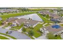 Aerial view of a residential neighborhood with a lake at 8064 Olive Brook Dr, Wesley Chapel, FL 33545