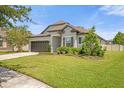 One-story home with a two-car garage and landscaped yard at 8064 Olive Brook Dr, Wesley Chapel, FL 33545