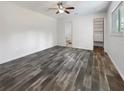 Spacious bedroom with wood-look floors and an ensuite bathroom at 3451 Sage St, Port Charlotte, FL 33948