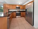 Modern kitchen with stainless steel appliances and wood cabinets at 3451 Sage St, Port Charlotte, FL 33948