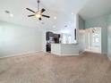 Spacious living room with carpeting and a view of the kitchen at 423 Durham Shore Ct, Apollo Beach, FL 33572