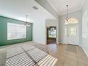 Bright dining room with tile floors and a view into the living room at 423 Durham Shore Ct, Apollo Beach, FL 33572
