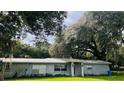Ranch-style home with a spacious lawn and mature trees at 4905 Nesmith Rd, Plant City, FL 33567