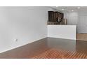 Living room with dark wood floors and kitchen access at 4916 White Sanderling Ct, Tampa, FL 33619