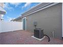 The backyard features a brick patio, white fence, and modern air conditioning unit at 17326 Alderwood Ln, Punta Gorda, FL 33982