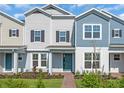 Charming two-story townhome with blue front door and manicured landscaping at 17326 Alderwood Ln, Punta Gorda, FL 33982