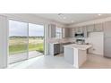 Modern kitchen island and view of backyard from sliding glass door at 17347 Peregrine Way, Punta Gorda, FL 33982