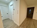 Entryway with white and dark brown doors and wood-look flooring at 4469 Cunningham St, Port Charlotte, FL 33948