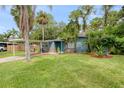 Cute bungalow home with carport and green lawn at 7329 Royal Palm Dr, New Port Richey, FL 34652