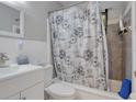 Clean bathroom with white vanity and floral shower curtain at 7329 Royal Palm Dr, New Port Richey, FL 34652
