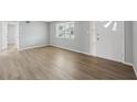 Bright living room with wood-look floors at 4935 Mirage Ave, Holiday, FL 34690