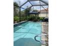 Enjoy this private screened-in pool surrounded by lush landscaping at 2633 Daisy Dr, North Port, FL 34289