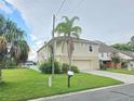 Two-story home with a large yard and palm trees at 3263 Sea Grape Dr, Hernando Beach, FL 34607