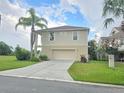Tan two-story house with a two-car garage at 3263 Sea Grape Dr, Hernando Beach, FL 34607