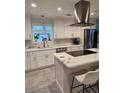 Modern white kitchen with large island and stainless steel appliances at 510 Wideview Ave, Tarpon Springs, FL 34689