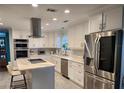 Modern white kitchen with large island and stainless steel appliances at 510 Wideview Ave, Tarpon Springs, FL 34689