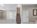 Home's entryway has tile floors and a staircase that leads upstairs at 12843 Buffalo Run Dr, Gibsonton, FL 33534