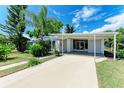 Mid-century ranch home with carport and landscaping at 21466 Meehan Ave, Port Charlotte, FL 33952