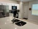 Modern kitchen features stainless steel appliances and white cabinetry at 3529 65Th Avenue E Cir, Sarasota, FL 34243