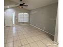 Spacious living room with tile flooring and neutral wall colors at 6115 Sand Key Ln, Wesley Chapel, FL 33545