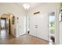 Well-lit entryway with tile flooring and access to other rooms at 12377 Fillmore St, Spring Hill, FL 34609