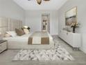 Large main bedroom with plush carpet and an ensuite bathroom at 7615 Campus Cv, Sarasota, FL 34243