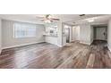 Bright living room with hardwood floors and ceiling fan at 7030 Coral Reef Dr, Port Richey, FL 34668