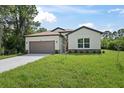 House exterior featuring a two-car garage at 4780 Alfa Ter, North Port, FL 34286