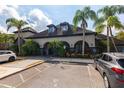Exterior view of apartment building with parking lot and landscaping at 12904 Sanctuary Cove Dr # 301, Temple Terrace, FL 33637