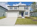 Two-story house with white garage door and gray siding at 168 Lazy Shore Dr, Nokomis, FL 34275