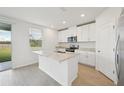 Modern kitchen with white cabinets and granite countertops at 168 Lazy Shore Dr, Nokomis, FL 34275