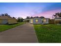 House exterior at dusk with a long driveway at 8025 Roy Dr, Punta Gorda, FL 33982